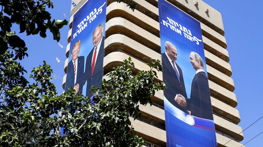 Two giant election banners showing Israeli Prime Minister Benjamin Netanyahu shaking hands with US President Donald Trump (L) and Russian President Vladimir Putin and a caption reading "Netanyahu, in another league," Tel Aviv, July 28, 2019. 