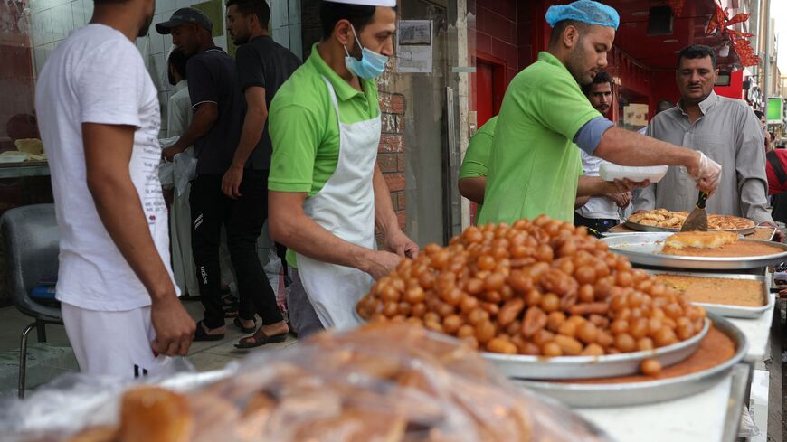 A shopkeeper prepares an order of traditional sweets for a customer in the capital Riyadh on March 27, 2023, during the Muslim fasting month of Ramadan. 