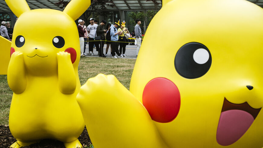 TOPSHOT - People queue to visit statues of Pokemon characters displayed outside the Lotte World Tower in Seoul on April 26, 2024. (Photo by ANTHONY WALLACE / AFP) (Photo by ANTHONY WALLACE/AFP via Getty Images)