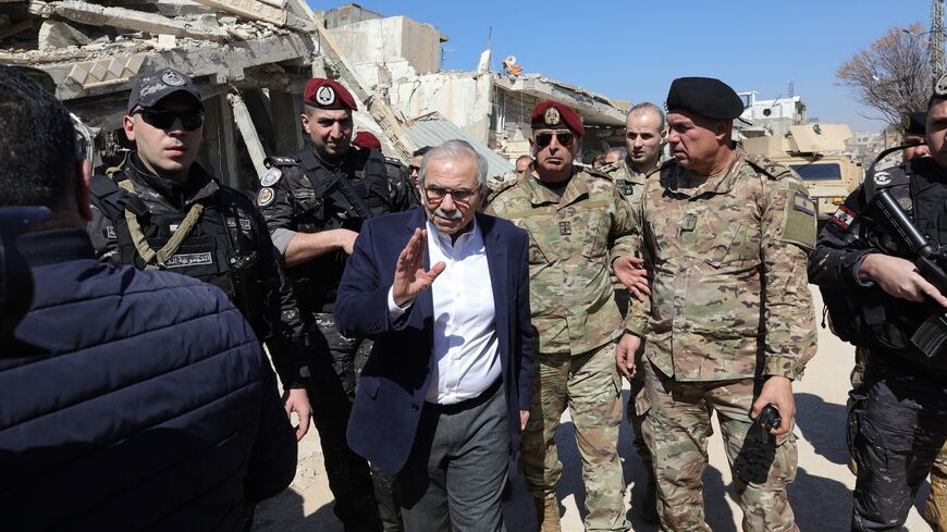 Lebanon's Prime Minister Nawaf Salam walks among Lebanese army soldiers as he visits the southern village of Khiam near the border with Israel, on Feb. 28, 2025.