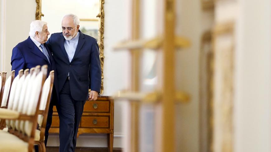 Iranian Foreign Minister Mohammad Javad Zarif (R) and his Syrian counterpart Walid al-Moualem walk before they start a meeting in Tehran August 5, 2015. Syrian Foreign Minister Walid al-Moualem arrived in Tehran on Tuesday for talks with officials from allies Iran and Russia that are expected to focus on efforts to end the civil war in his country. REUTERS/Raheb Homavandi/TIMA ATTENTION EDITORS - THIS PICTURE WAS PROVIDED BY A THIRD PARTY. REUTERS IS UNABLE TO INDEPENDENTLY VERIFY THE AUTHENTICITY, CONTENT,