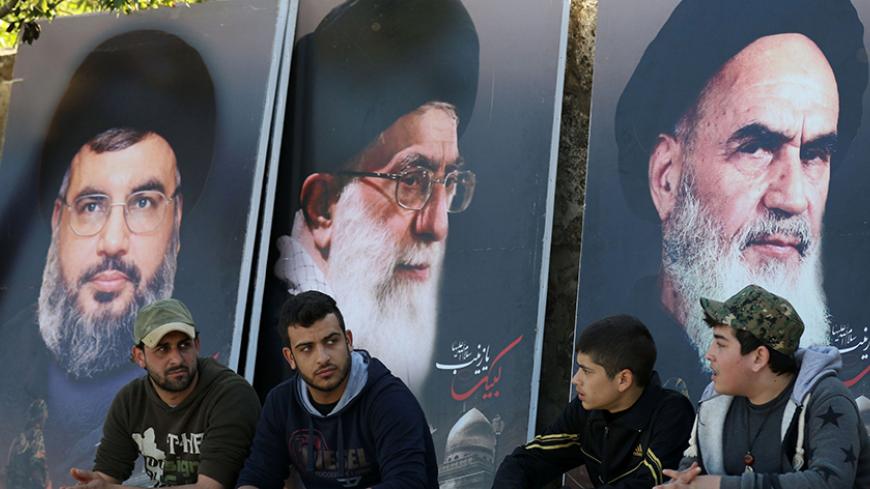 Lebanese sit in front of giant posters bearing portraits of Hassan Nasrallah, the head of Lebanon's militant Shiite Muslim movement Hezbollah (L), the founder of Iran's Islamic Republic, Ayatollah Ruhollah Khomeini (R) and Iran's supreme leader Ayatollah Ali Khamenei (C) on March 1, 2016, in the southern town of Kfour, in the Nabatiyeh district during the funeral of a Hezbollah fighter, Mohammed Hassan Nehme, who was killed while fighting alongside Syrian government forces in Syria.
Mohammed Hassan Nehme wa