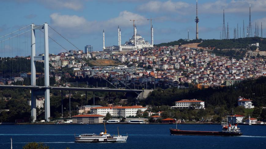A ferry, with a new mosque under construction at Camlica hill in the background, sets sail in the Bosphorus in Istanbul, Turkey, July 31, 2017. Picture taken July 31, 2017. REUTERS/Murad Sezer - RC1F1AF244B0