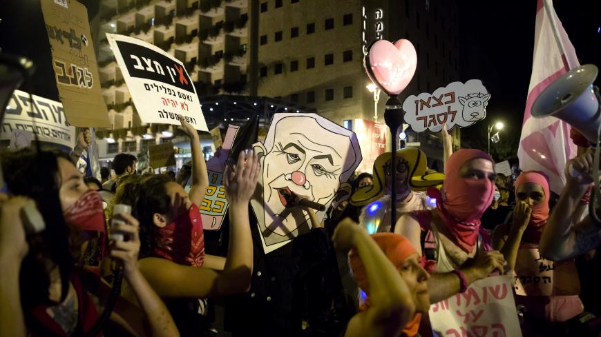 JERUSALEM, ISRAEL - SEPTEMBER 20: Protesters hold signs during a demonstration against Israeli Prime Minister Benjamin Netanyahu on September 20, 2020 in Jerusalem, Israel. As the country grapples with a surge in Covid-19 cases it has imposed a three-week lockdown that coincides with Rosh Hashanah, the Jewish new year, and Yom Kippur, the Day of Atonement.  (Photo by Amir Levy/Getty Images)