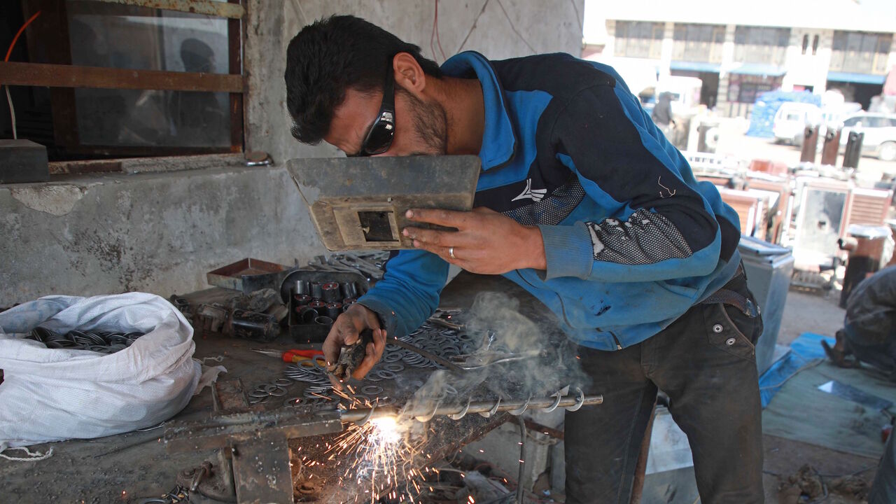 A Syrian labourer works at a workshop specialised in building pistachio-powered heaters in al-Dana town in Syria's northwestern province of Idlib on December 18, 2019.