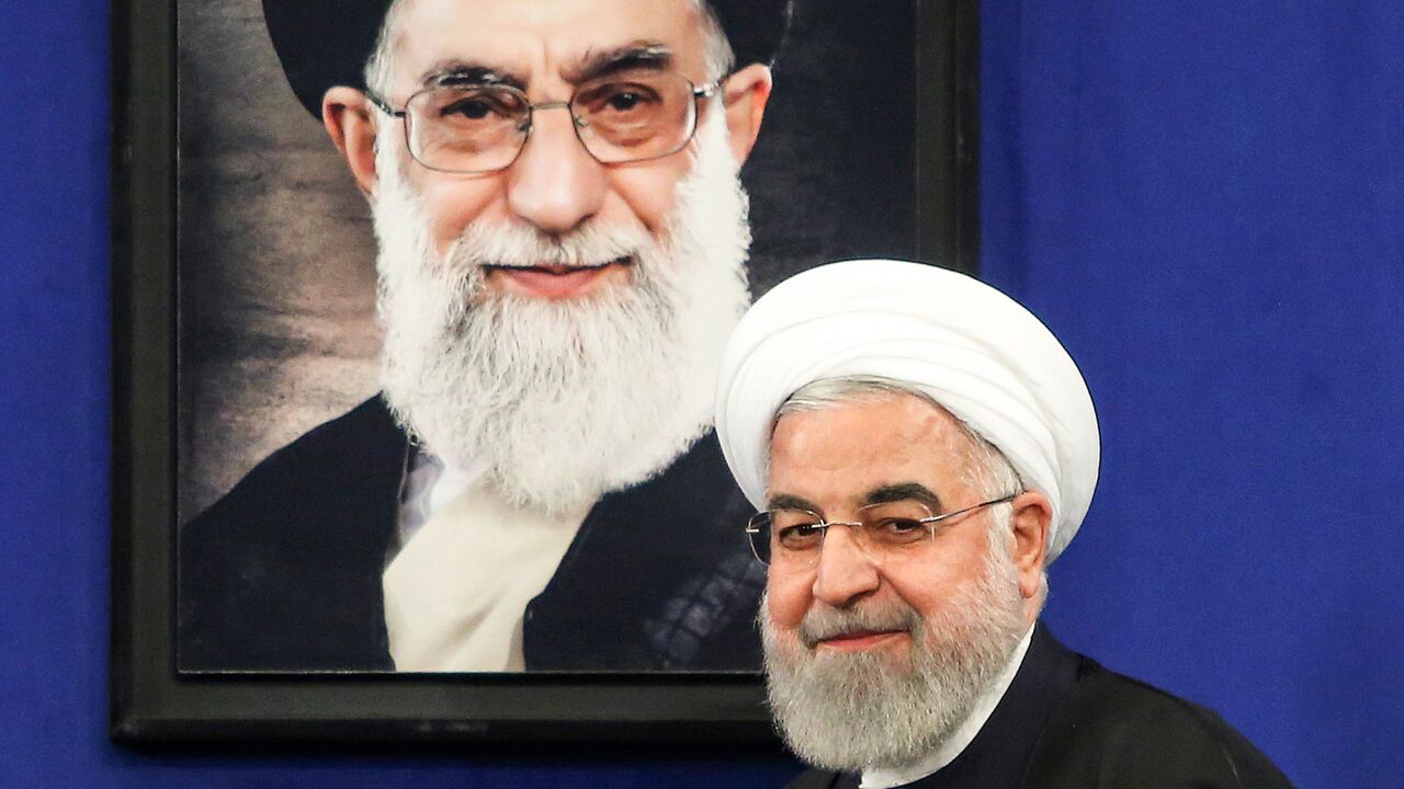 Rouhani with Khamenei portrait behind