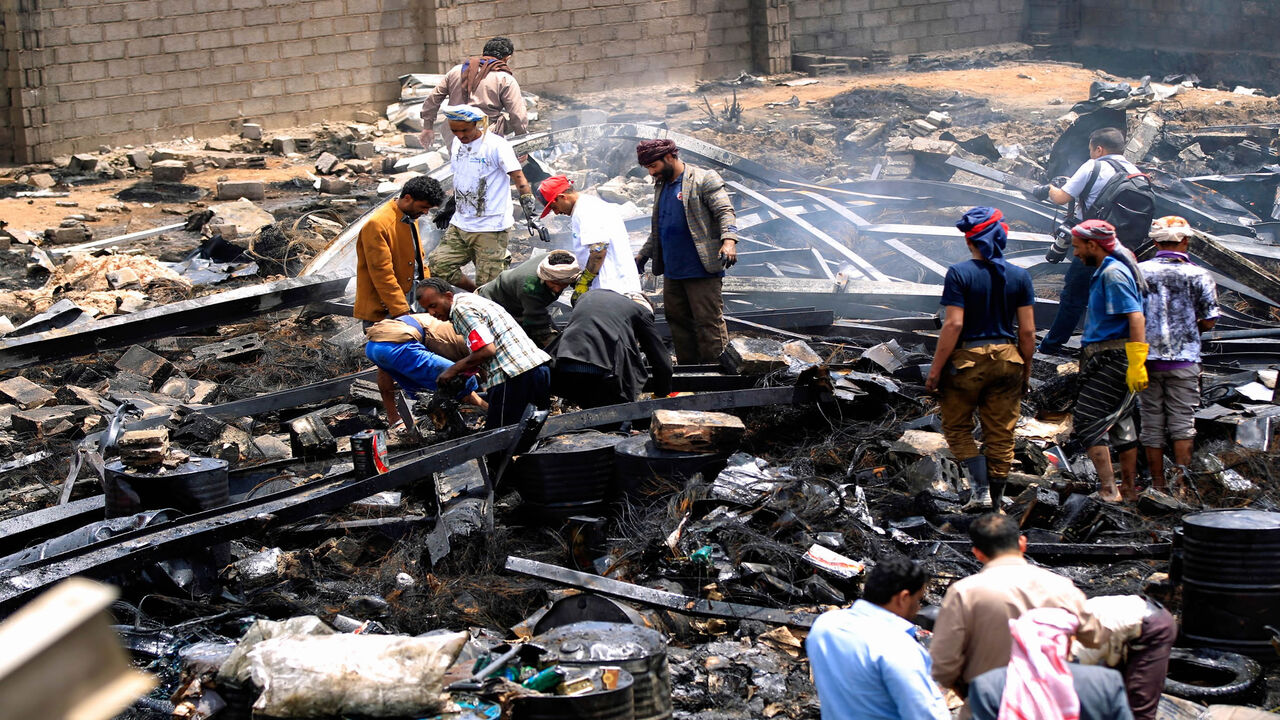 Workers search through debris at a warehouse, after it was reportedly hit in an airstrike by the Saudi-led coalition, Sanaa, Yemen, July, 2, 2020.