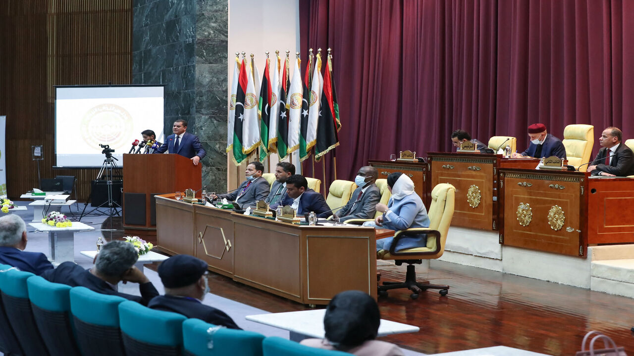 Libya's Prime Minister-designate Abdul Hamid Dbeibah addresses lawmakers during the first reunited parliamentarian session, in the coastal city of Sirte, Libya, March 9, 2021.