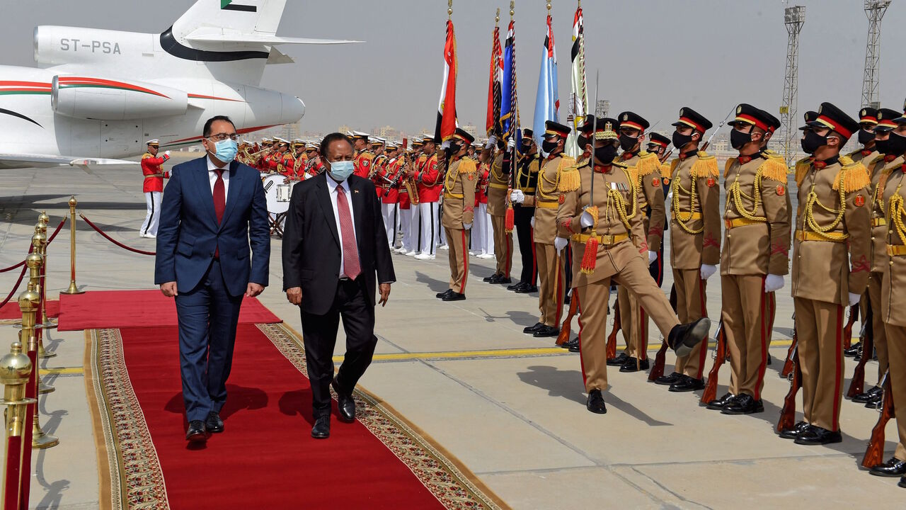 Egyptian Prime Minister Mostafa Madbouly (L) welcomes his Sudanese counterpart Abdalla Hamdok upon his arrival in the Egyptian capital Cairo, on March 11, 2021. 