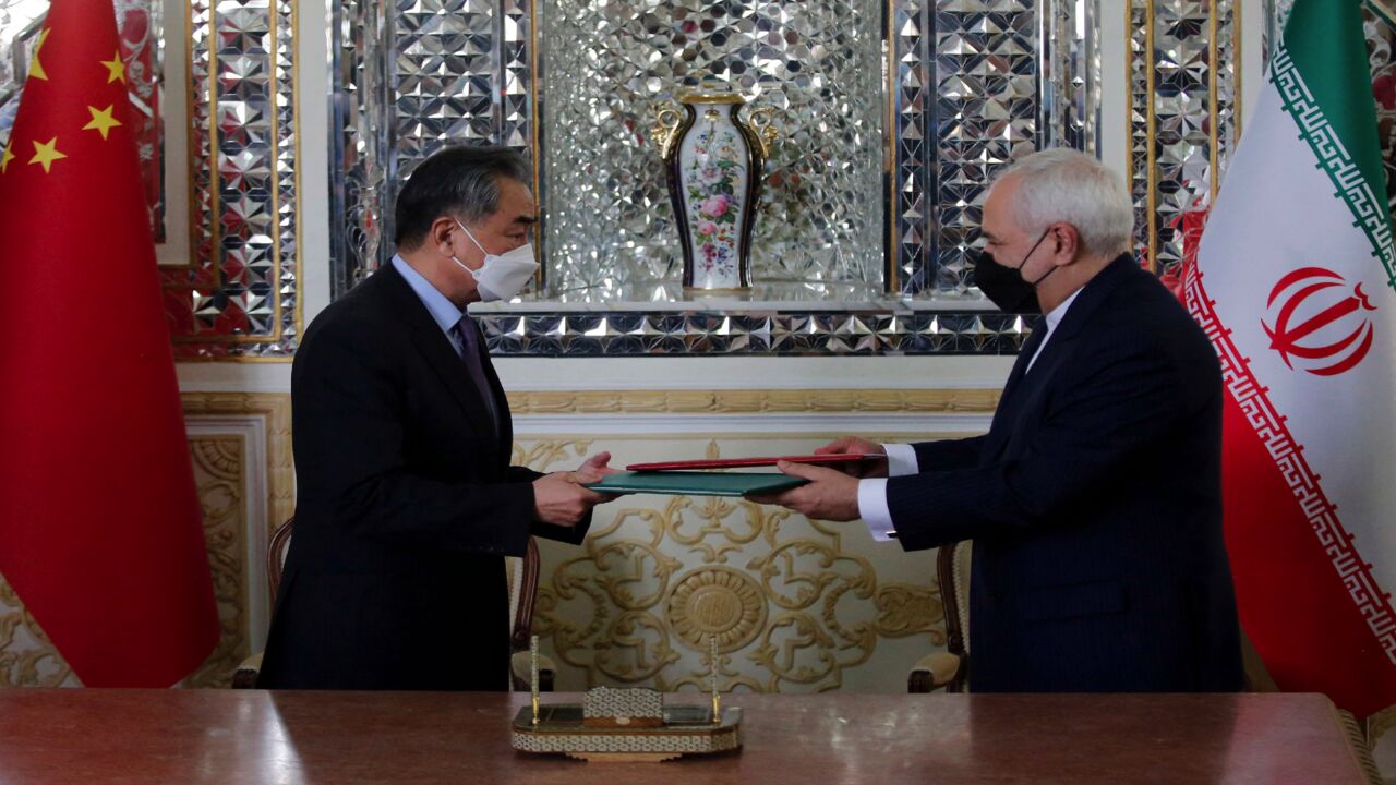 Iranian Foreign Minister Mohammad Javad Zarif (R) and his Chinese counterpart, Wang Yi, are pictured during the signing of an agreement in the capital, Tehran, on March 27, 2021. Iran and China signed what state television called a "25-year strategic cooperation pact," as the US rivals move closer together.