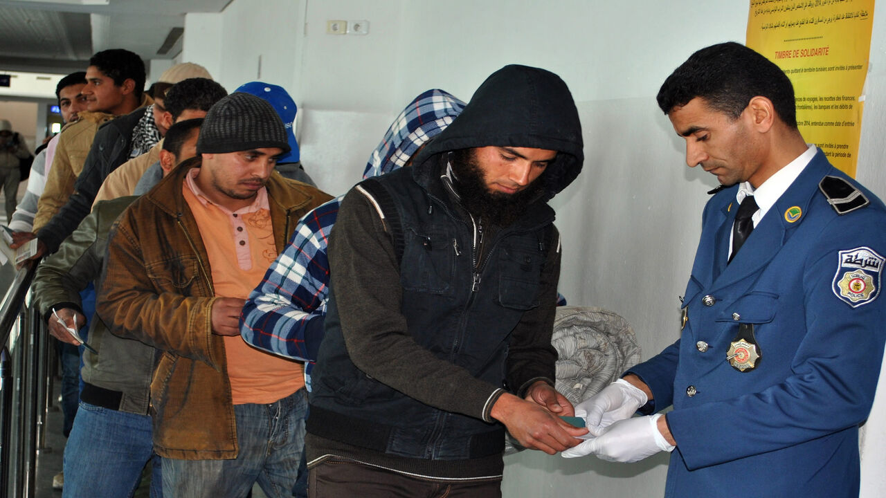 Egyptians, who were formerly residing in Libya, have their documents checked by Tunisian customs at Djerba airport on the Tunisian-Libyan border, before their departure for Cairo, Egypt, Feb. 23, 2015.