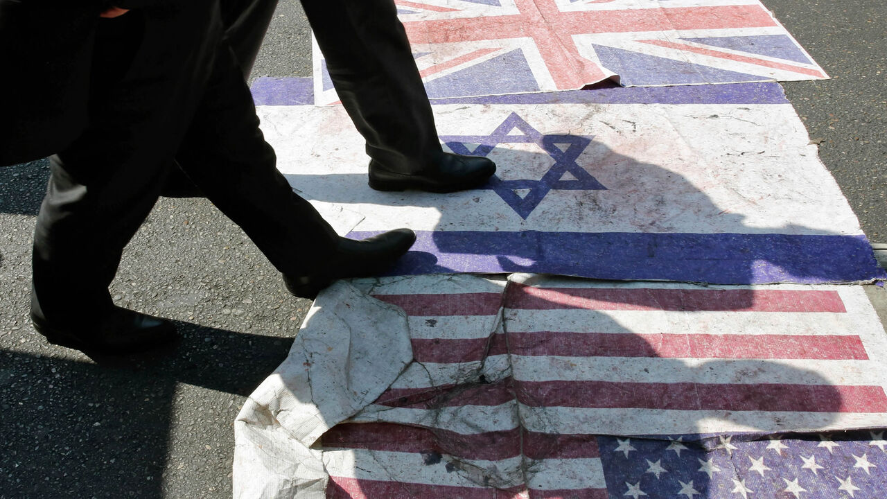 Iranians steps on the US, Israeli and British flag during a parade marking Quds Day, Tehran, Iran, May 31, 2019.