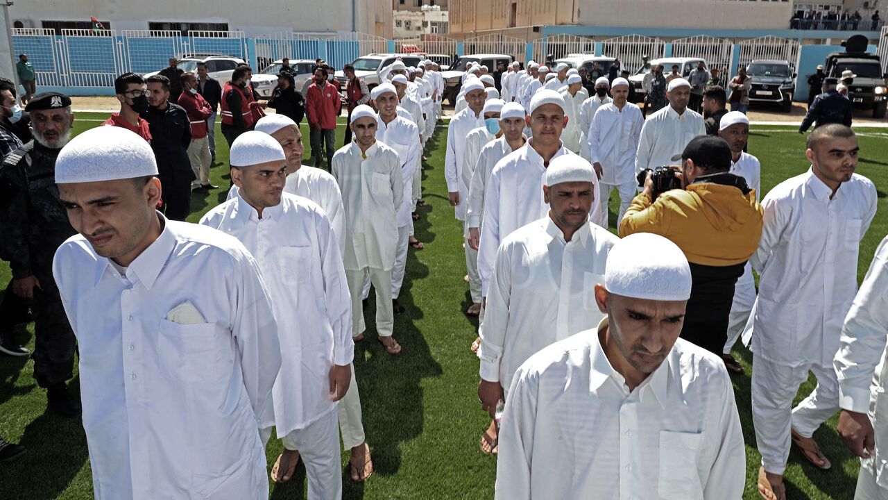 Prisoners of war, loyal to the forces of Libya's eastern military strongman Khalifa Haftar, are pictured upon their release by the new Libyan unity government on March 31, 2021 in the port city of Zawiya, 50 kilometres (30 miles) west of the Libyan capital Tripoli, following the latest peace deal between the North African country's former rival governments. - The two sides have completed more than one prisoner swap this year as Libya's eastern administration officially handed over power to a new executive t