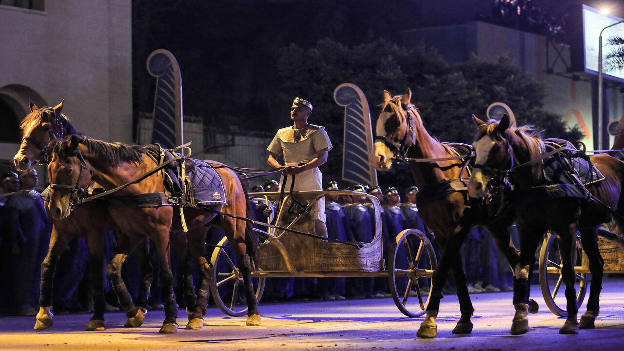 A performer rides a two-horse chariot at the start of the parade of 22 ancient Egyptian royal mummies departing from the Egyptian Museum in Tahrir Square to the new National Museum of Egyptian Civilization in Fustat, Cairo, Egypt, April 3, 2021.