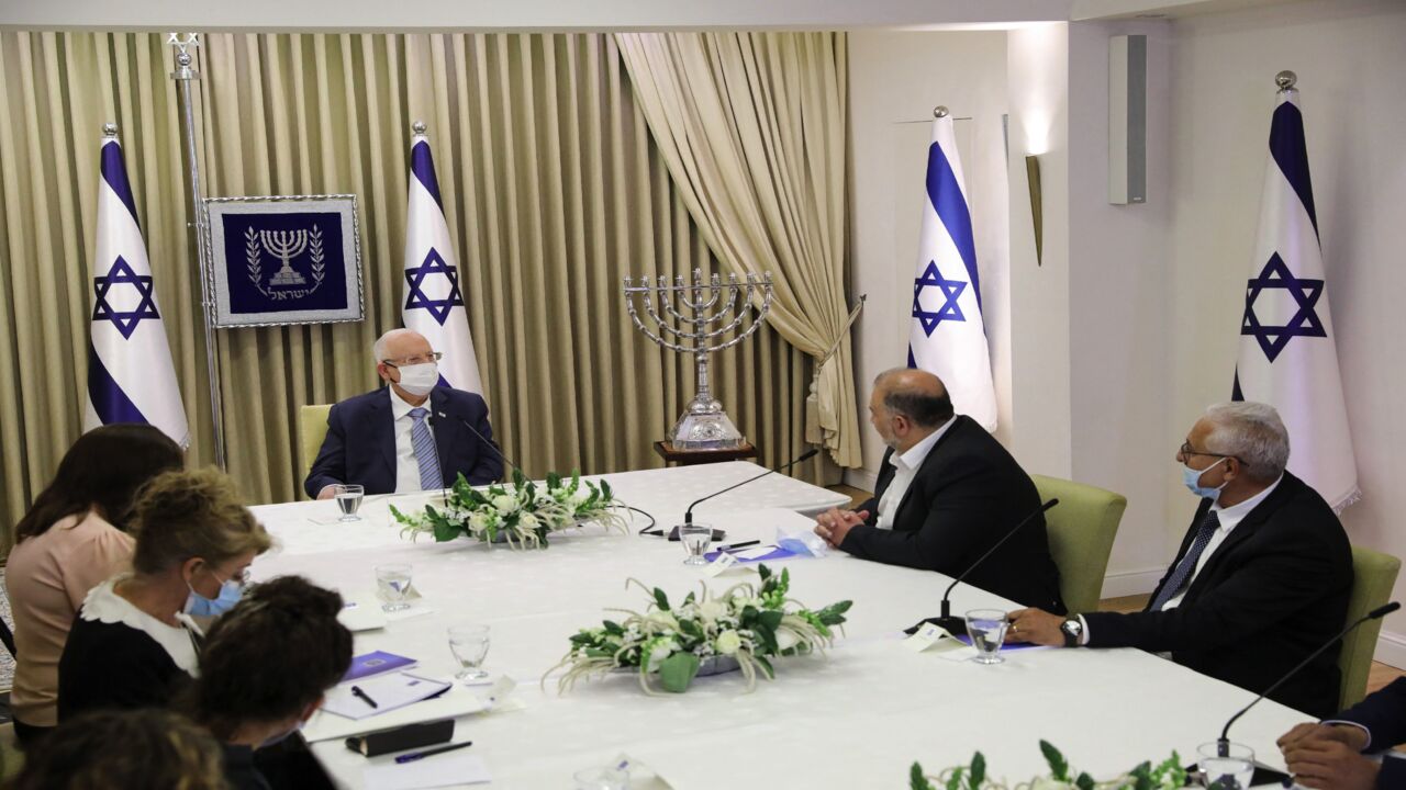 Israeli Arab politician, leader of the United Arab List Mansour Abbas (R) attends consultations with Israeli President Reuven Rivlin (L) on who might form the next coalition government, at the president's residence in Jerusalem, on April 5, 2021.