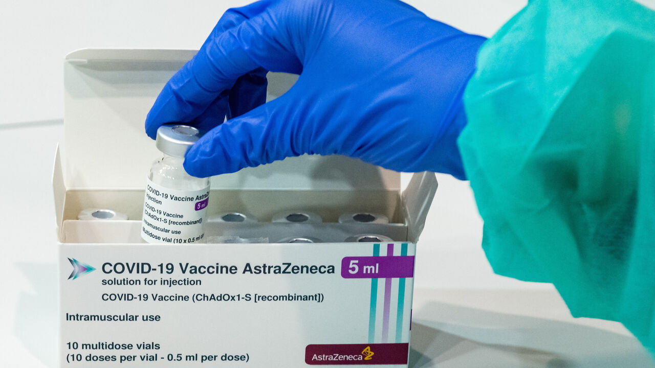 Medical staff handle an empty vial of the AstraZeneca vaccine against COVID-19 at a vaccination center at the Messe trade fair grounds during the third wave of the coronavirus pandemic on April 8, 2021 in Erfurt, Germany. 