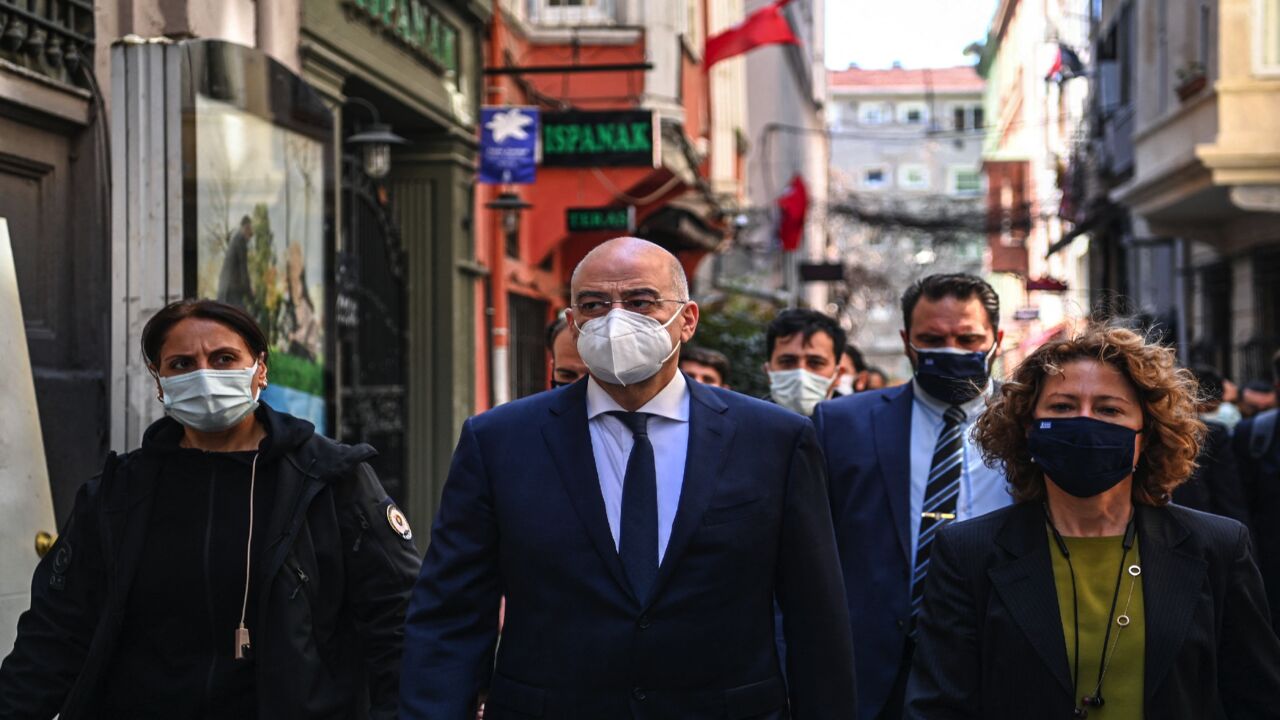 Greece's Foreign Minister Nikos Dendias (C) walks on Istiklal Avenue after his meeting with the Patriarch of Constantinople at the Greek Consulate in Istanbul on April 14, 2021.