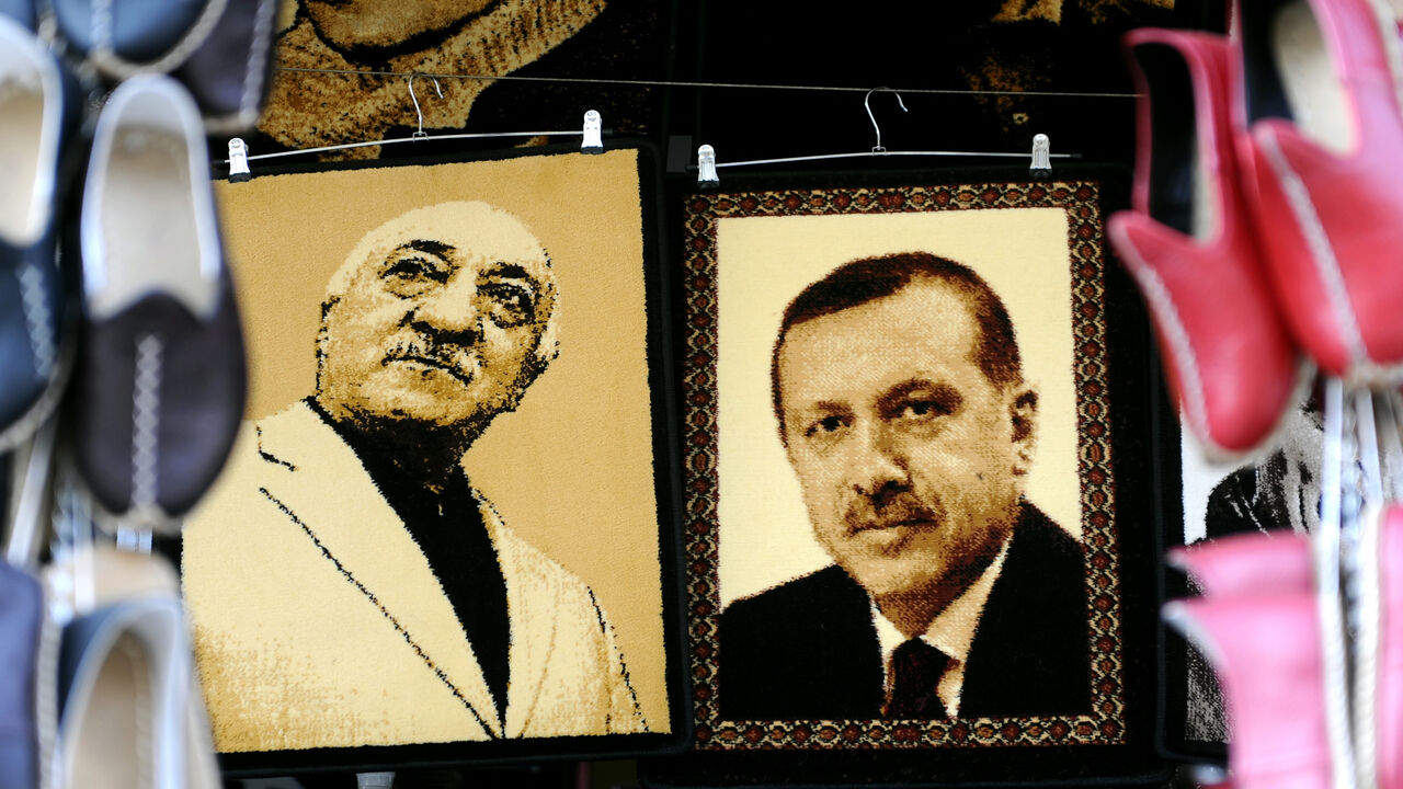Embroidered images of United States-based Turkish cleric Fethullah Gulen (L) and Turkey's Prime Minister Recep Tayyip Erdogan (R) are displayed in a shop in a market, Gaziantep, near the Turkish-Syrian border, Jan. 17, 2014.