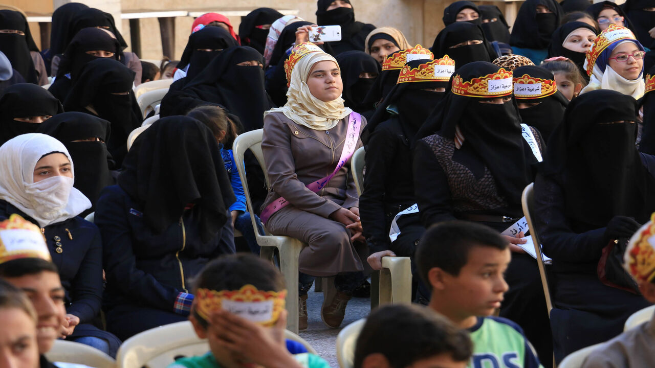 Syrian women and children attend a ceremony to celebrate the last day of the school year in the rebel-held town of Azaz, in northern Syria, May 24, 2017.