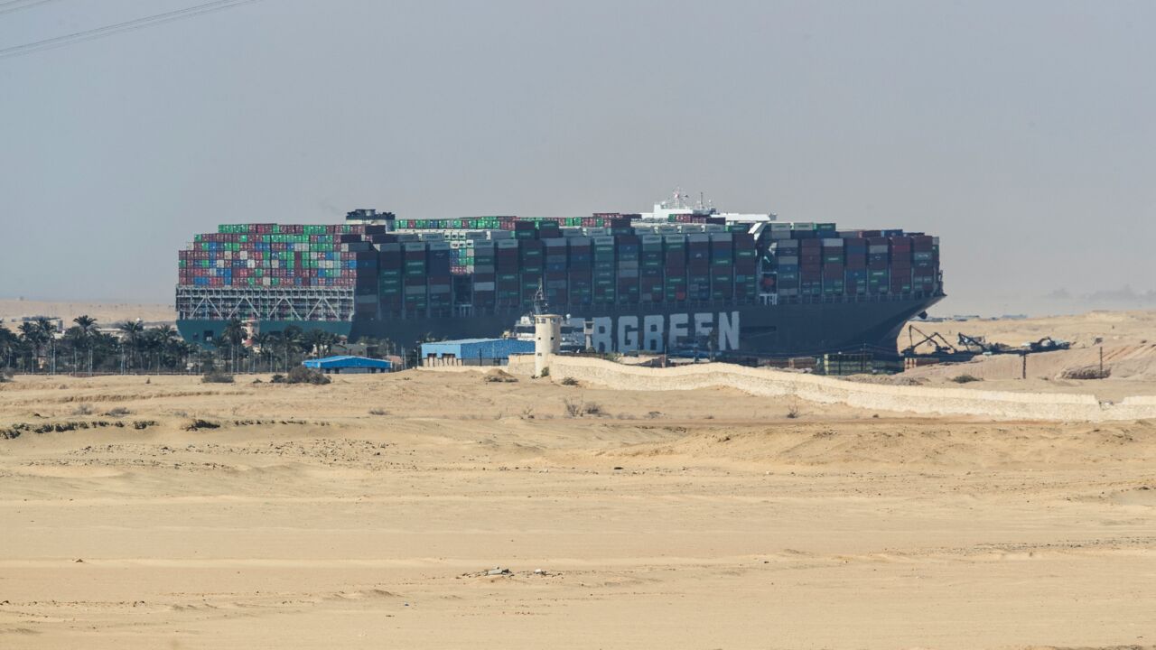 The container ship Ever Given is seen at the Suez Canal on March 28, 2021, in Suez, Egypt. Work continues to free the Ever Given, a huge container ship stuck sideways in Egypt's Suez Canal. Dredgers have been working on the port side of the ship in an attempt to remove sand and mud and dislodge the vessel. The Suez Canal is one of the world's busiest shipping lanes and the blockage has created a backlog of vessels at either end, raising concerns over the impact the accident will have on global shipping and 