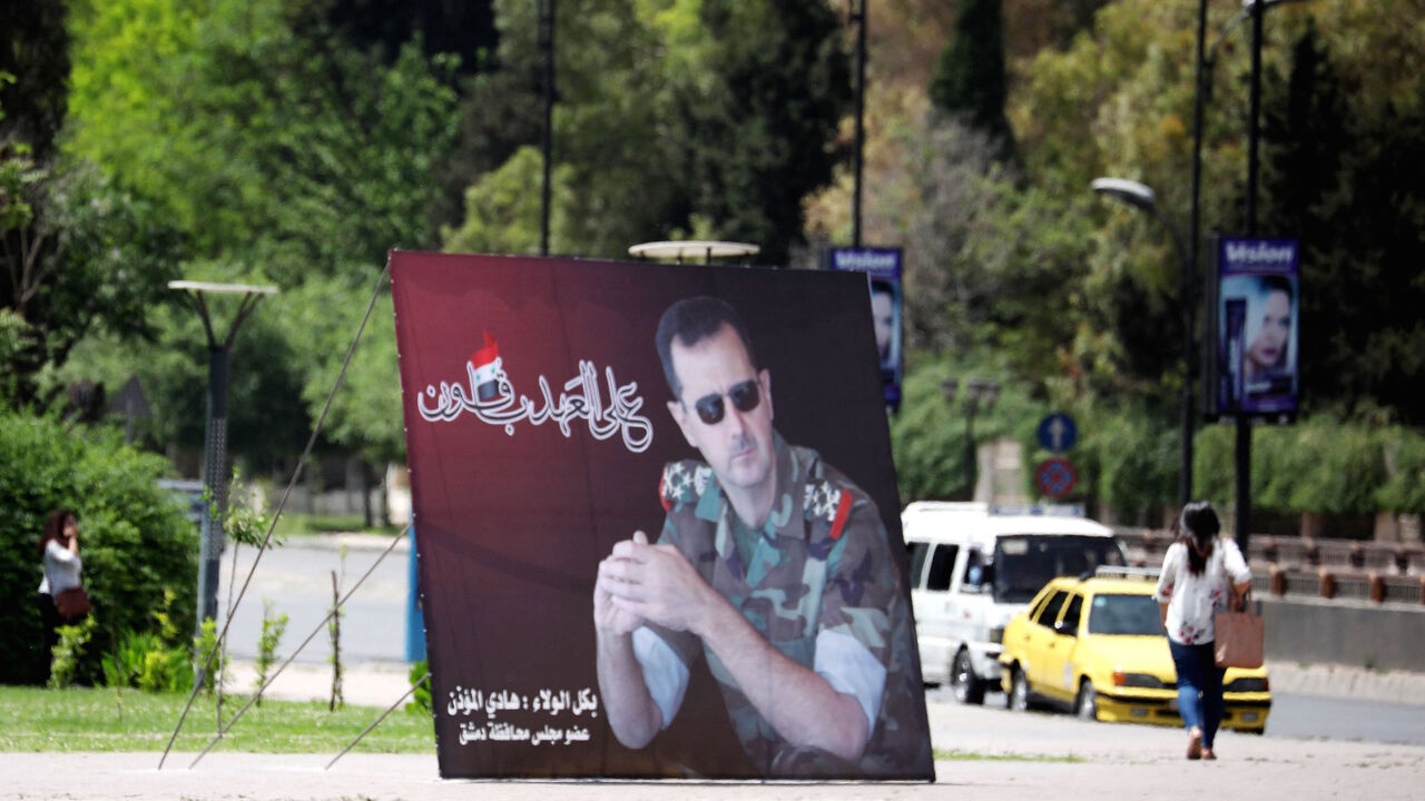A photo taken on May 3, 2021 shows a giant portrait of President Bashar al-Assad at the Umawiyin square in Syria's capital Damascus, ahead of this month's presidential elections. 