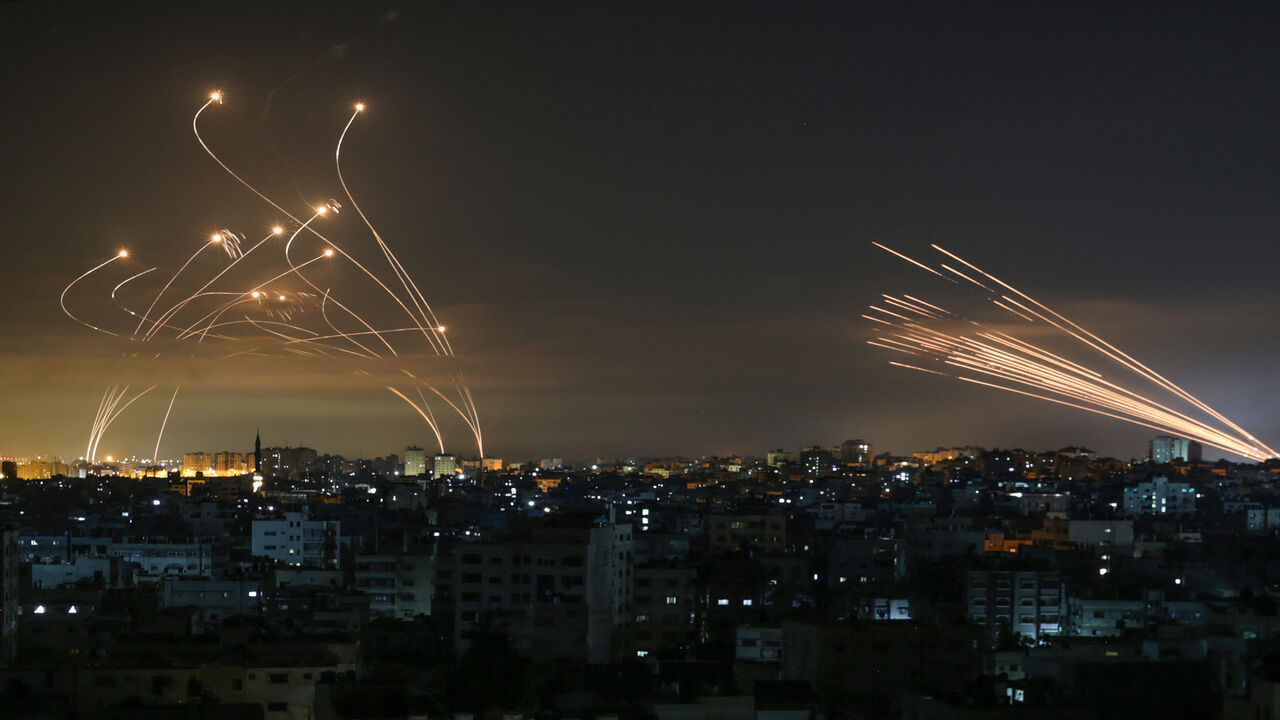Rockets are seen in the night sky fired toward Israel from Beit Lahia, northern Gaza Strip, May 14, 2021.