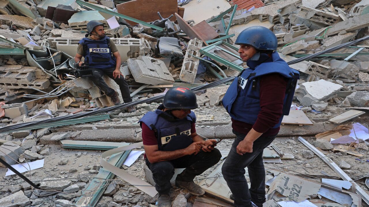 Journalists sit on to the rubble of Jala Tower, which was housing international press offices, following an Israeli airstrike in the Gaza Strip on May 15, 2021. The airstrike demolished the 13-floor building housing Qatar-based Al-Jazeera television and American news agency The Associated Press in the Gaza Strip.