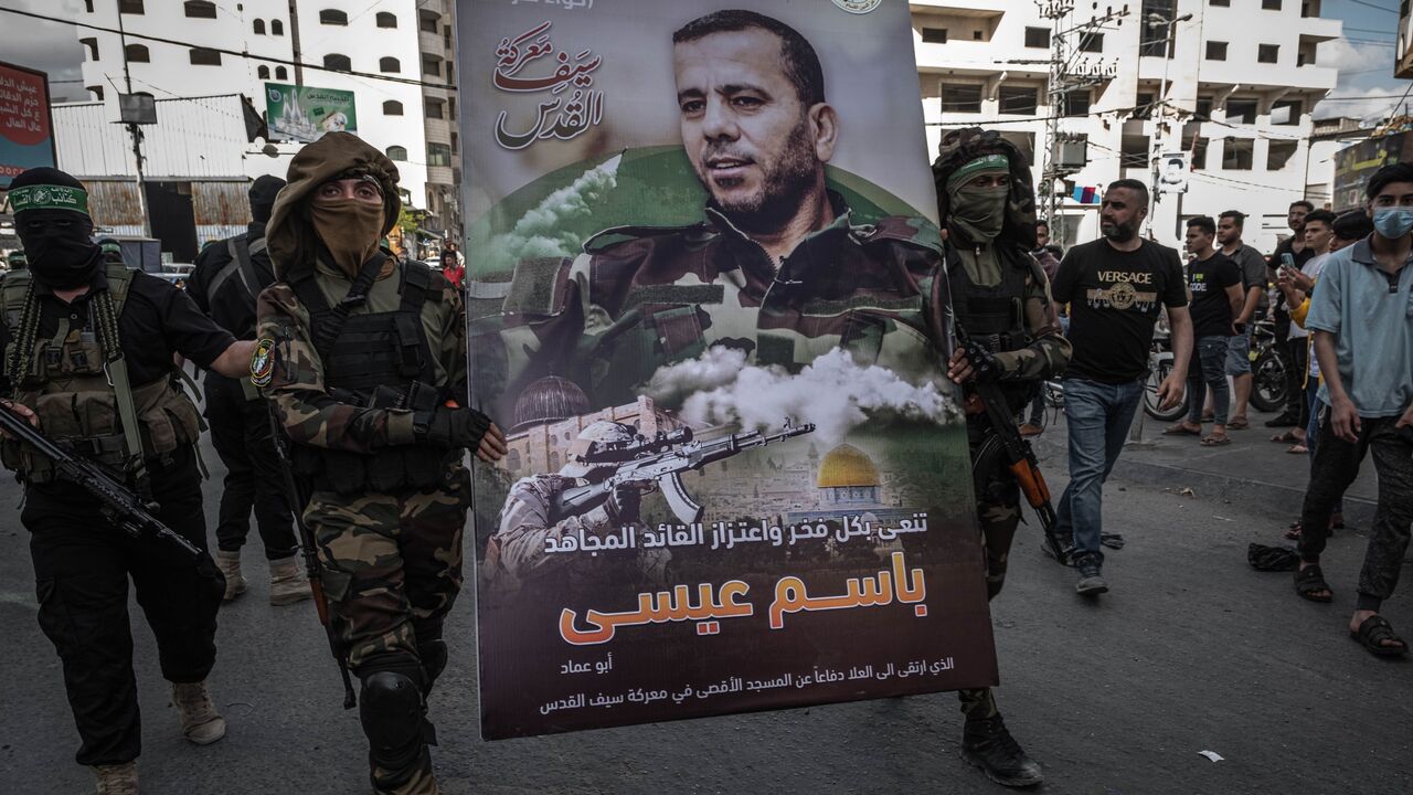 Al-Qassam Brigades fighters march in tribute to Bassem Issa
