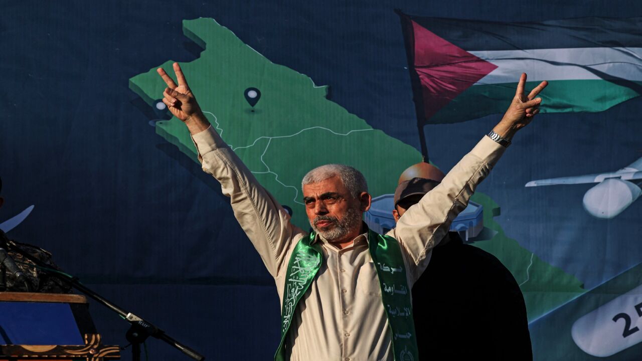 Yahya Sinwar, leader of the Palestinian Hamas movement, gestures on stage during a rally in Gaza City on May 24, 2021. A cease-fire was reached late last week after 11 days of deadly violence between Israel and the Hamas movement, which runs Gaza, stopping Israel's devastating bombardment on the overcrowded Palestinian coastal enclave.