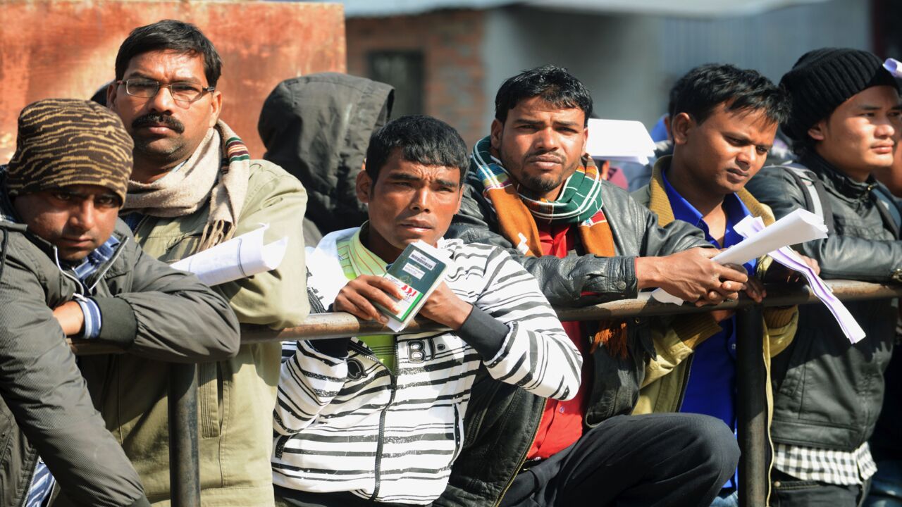Nepalese migrant workers queue to receive official documents in order to leave Nepal from the Labor Department in Kathmandu on January 27, 2014. Nearly 200 Nepali migrant workers died in Qatar in 2013, figures that highlight the grim plight of laborers in the Gulf nation.