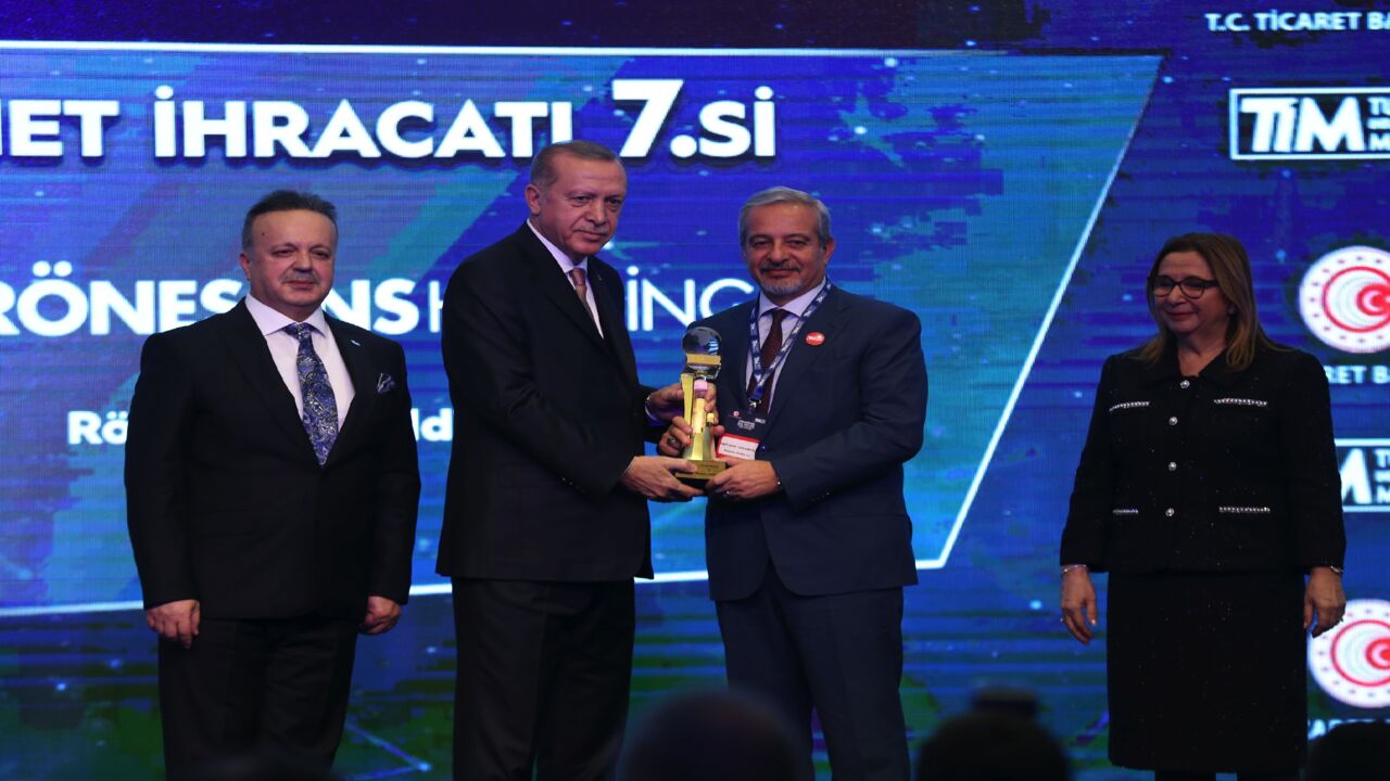 Turkish President Recep Tayyip Erdogan (2nd L) gives an award to Ronesans Holding Member of Board Ferit Seyfi Yagmuroglu (2nd R) during Turkey's 500 Largest Service Exporters Award Ceremony in Istanbul, Turkey, on Dec. 21, 2018. 