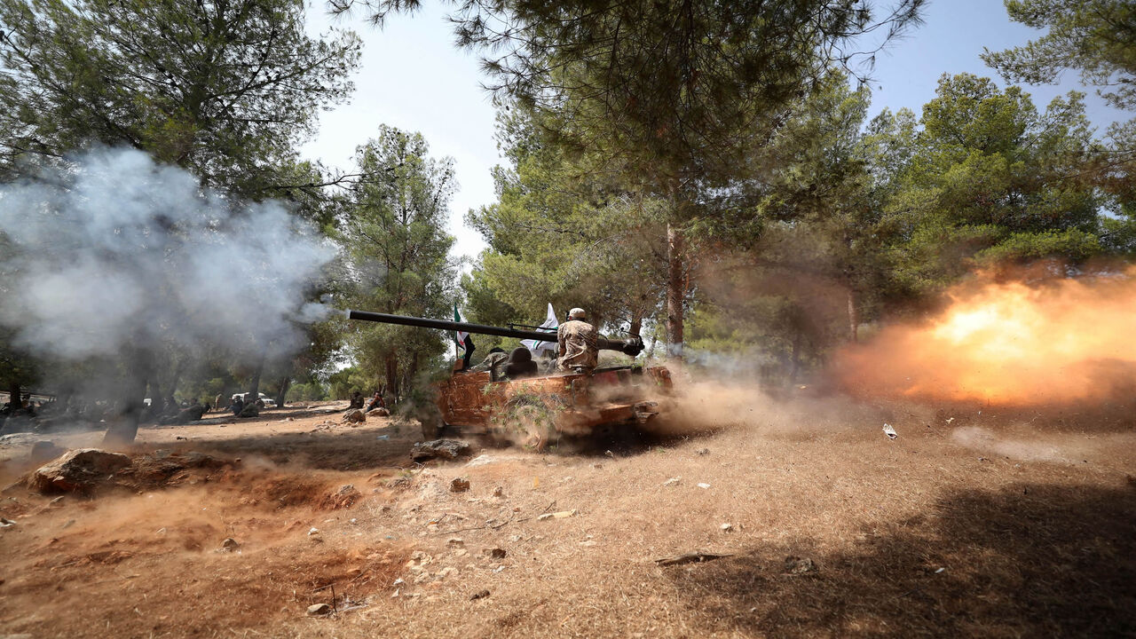 A special forces mission personnel affiliated with the Turkish-backed National Front for Liberation shows his skills during a graduation ceremony, al-Ghazawiya, near Afrin in the rebel-held northern countryside of Aleppo province, Syria, July 28, 2020.