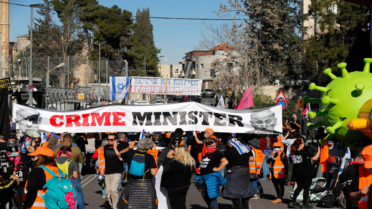 Israelis demonstrate outside the court as Prime Minister Benjamin Netanyahu's corruption trial resumes in occupied East Jerusalem, Feb. 8, 2021.