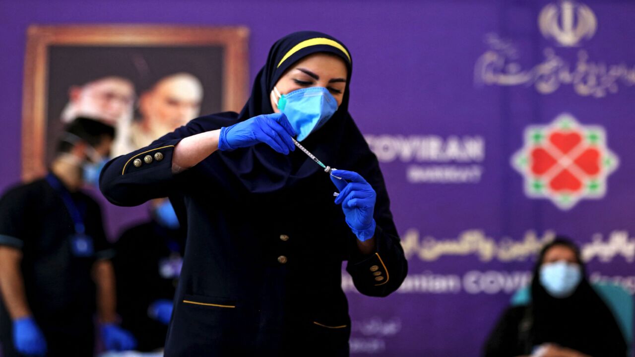 An Iranian health worker prepares an injection of the Iranian-made COVID-19 vaccine during the start of the second phase of trials in the capital, Tehran, on March 15, 2021.