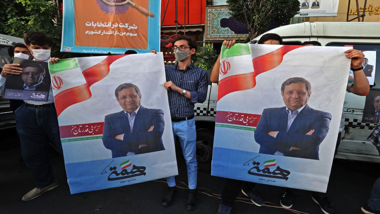 Supporters of Iran's Reformist candidate Abdolnasser Hemmati hold his campaign posters during a rally in the Iranian capital, Tehran, on June 15, 2021, three days ahead of the Islamic Republic's June 18 presidential election.