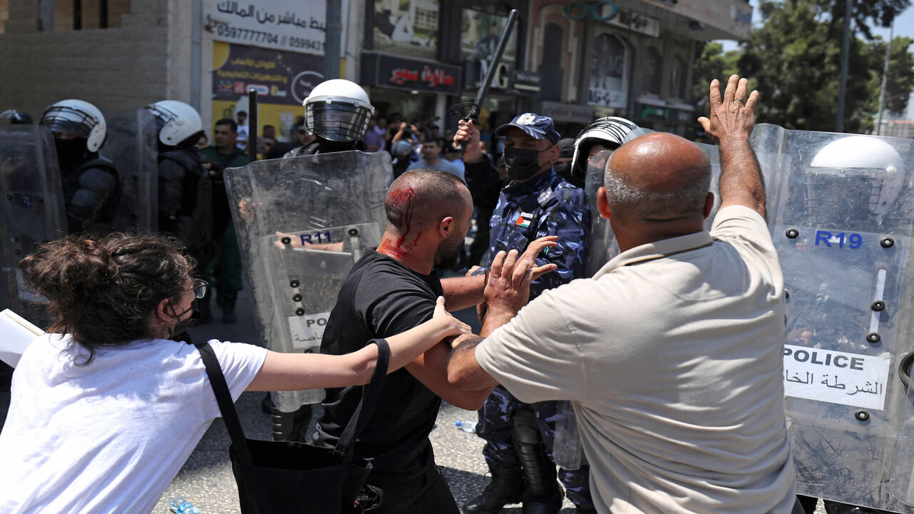 Palestinian security forces push a protest during a demonstration calling for Palestinian President Mahmoud Abbas to quit, following the death of Palestinian human rights activist Nizar Banat who died shortly after being arrested, Ramallah, West Bank, June 24, 2021.