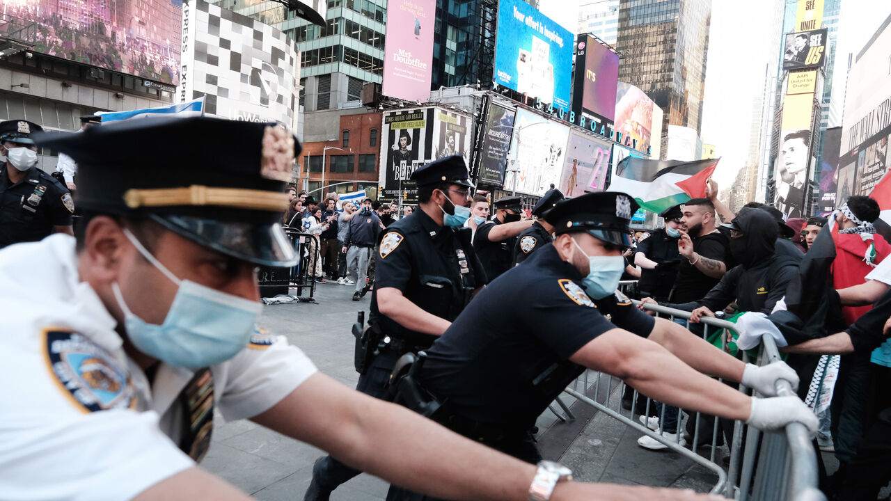 Pro Palestinian protesters face off with a group of Israel supporters and police in a violent clash in Times Square on May 20, 2021 in New York City. 