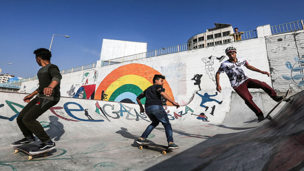 Palestinian youths ride their skateboards near the sea port of Gaza City, Gaza Strip, March 20, 2019.