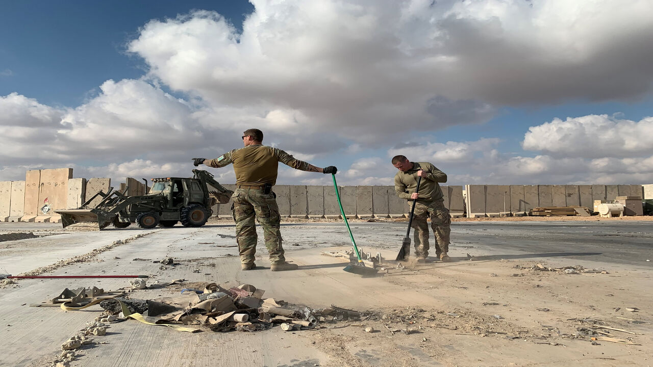 This picture taken during a press tour organized by the US-led coalition fighting the remnants of the Islamic State shows a bulldozer clearing debris from Ain al-Asad military air base in the western province of Anbar, Iraq, Jan. 13, 2020.