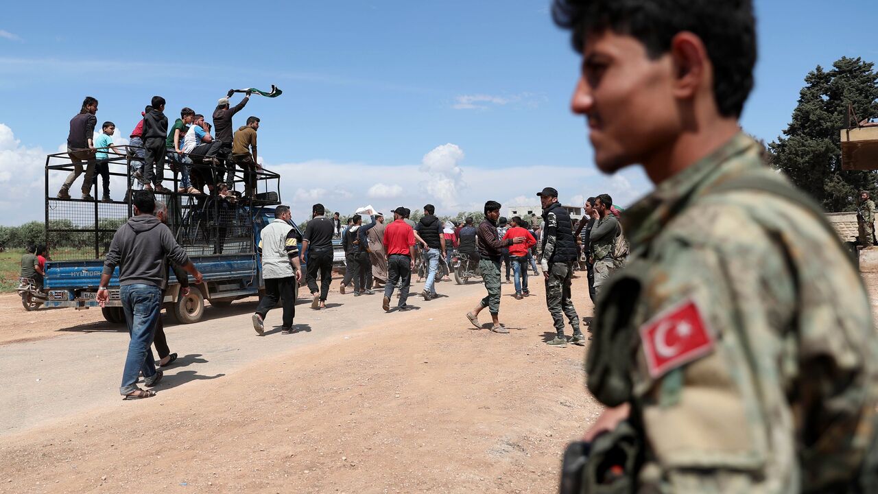 Demonstrators gather during a protest in the village of Maaret al-Naasan in Idlib province, to protest against a reported attack by Hayat Tahrir al-Sham, Syria, May 1, 2020.