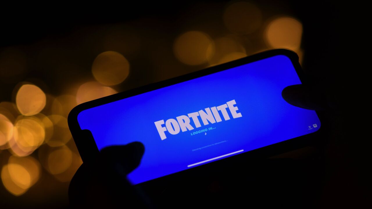 This illustration picture shows a person logging into Epic Games' Fortnite on their smartphone on Aug. 14, 2020.