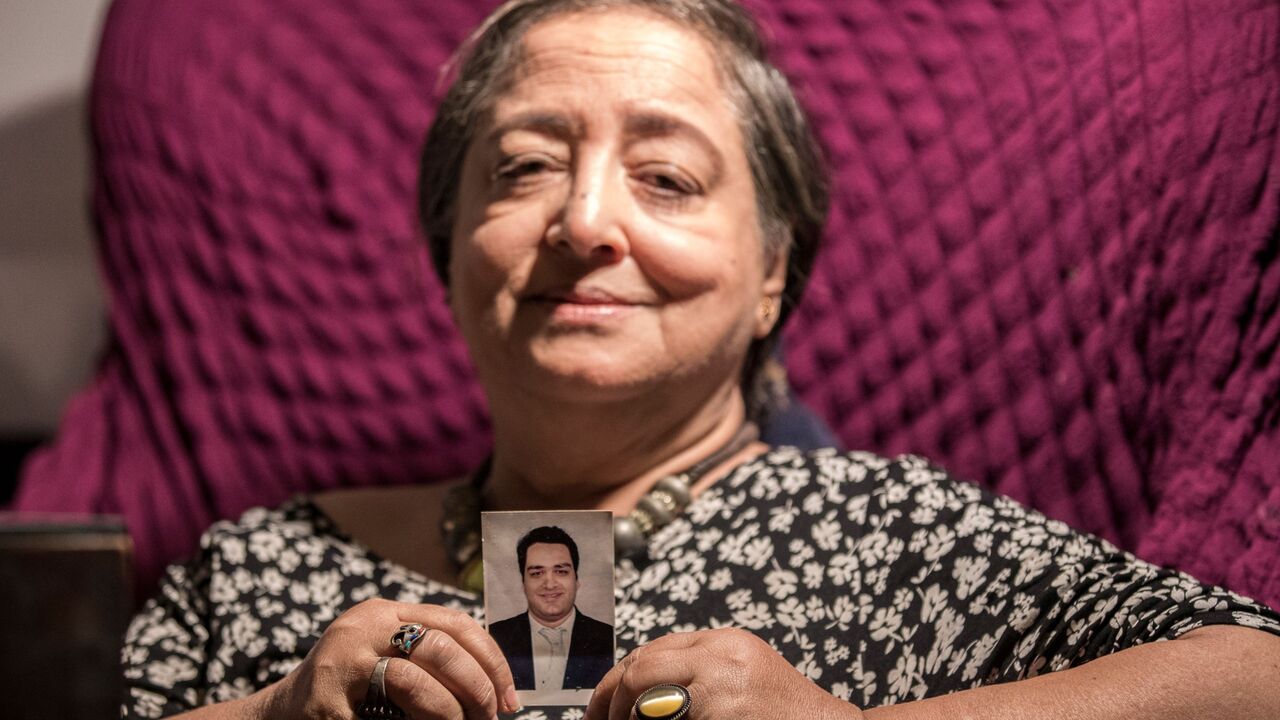 Egyptian mother holds picture of imprisoned son