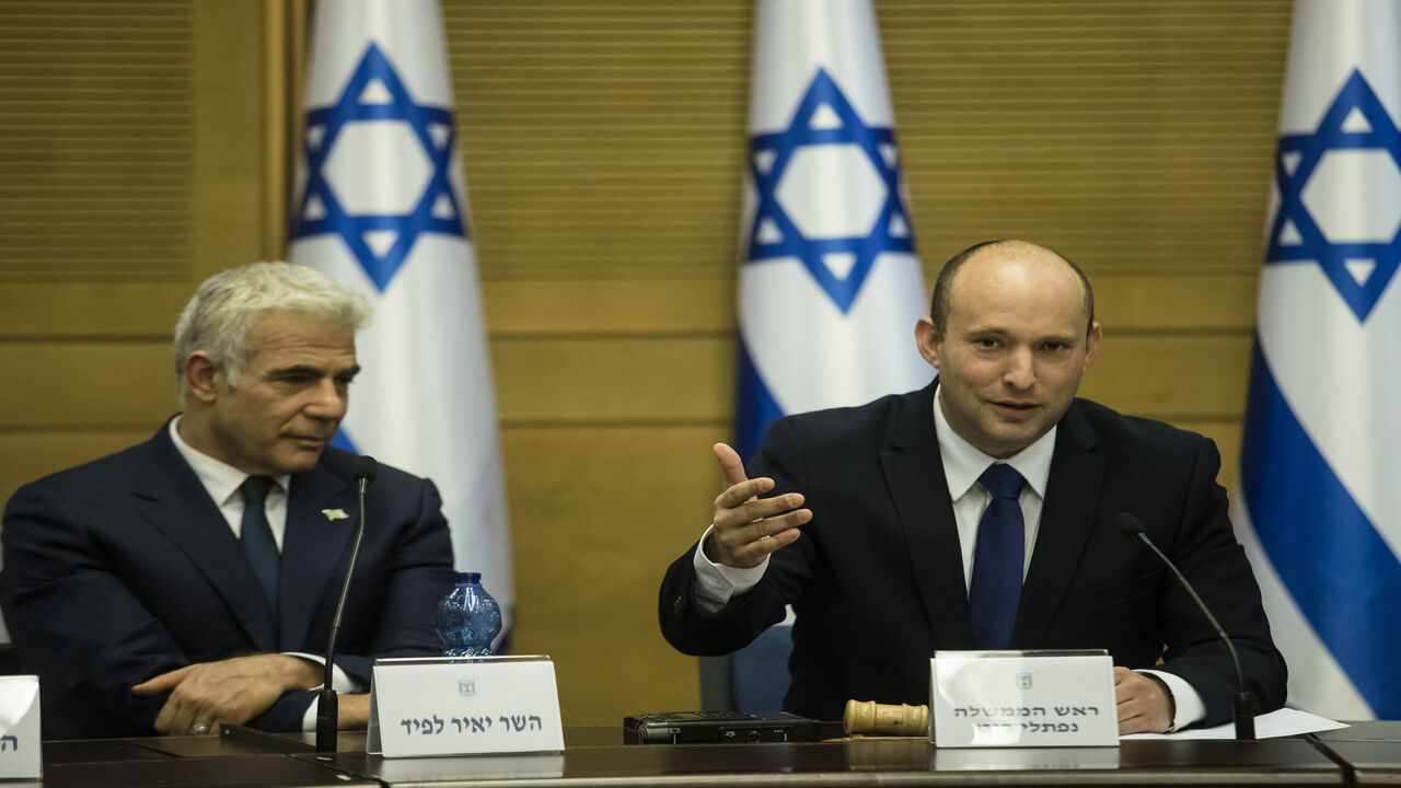 Incoming Israeli Prime Minister Naftali Bennett (R) and Foreign Minister Yair Lapid attend the first meeting of the new government, Jerusalem, June 13, 2021.