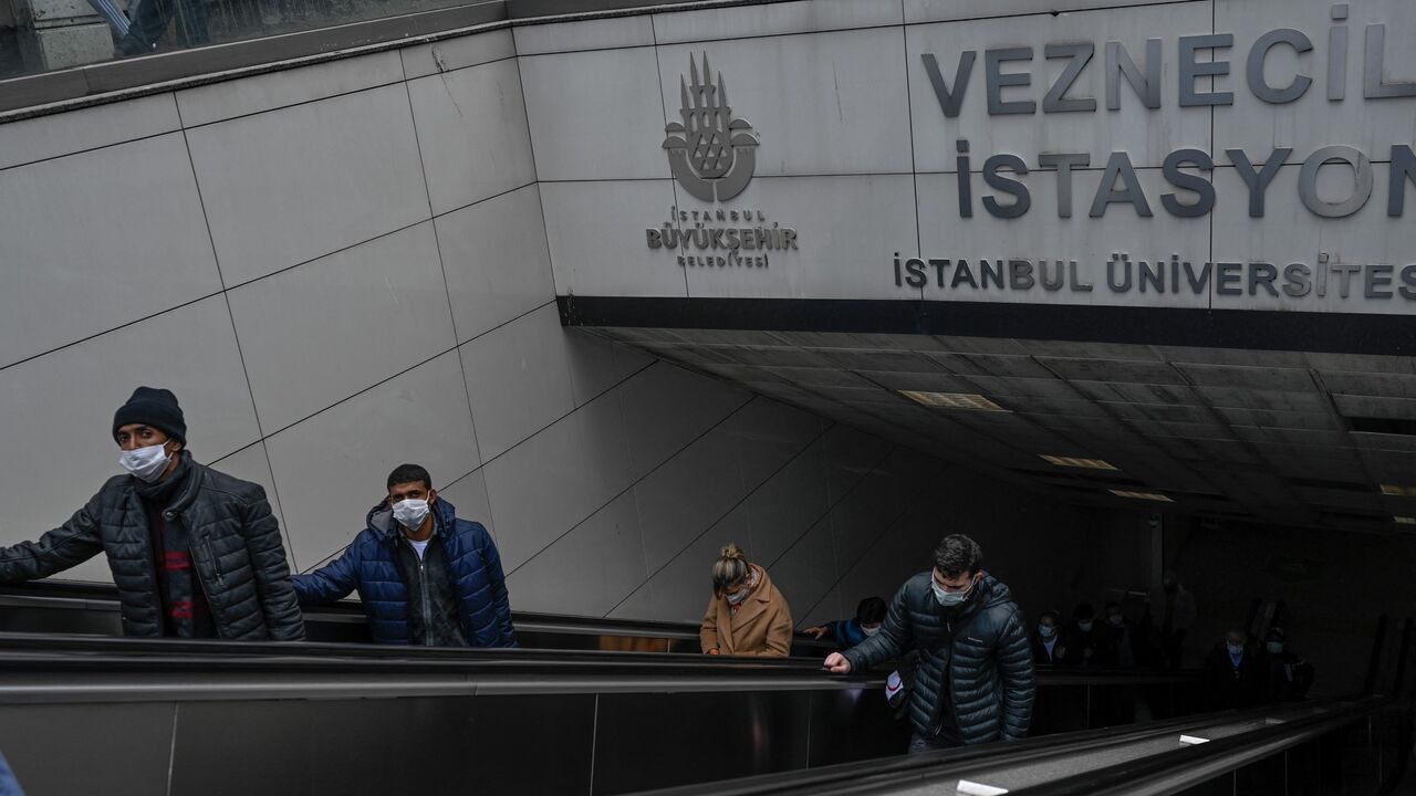 People come out from a metro station at Laleli in Istanbul, on March 22, 2021