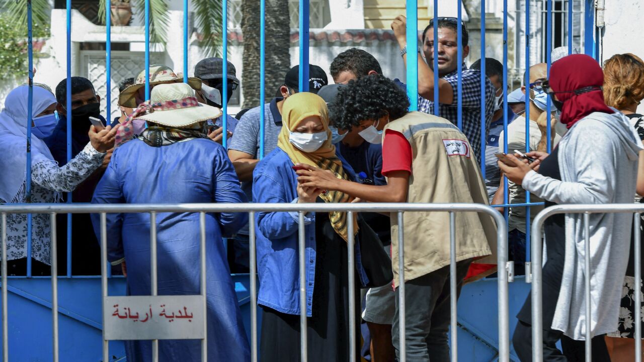Tunisians wait for their turn to receive a COVID-19 vaccine at an inoculation center in Ariana governorate near the capital Tunis on Aug. 8, 2021.