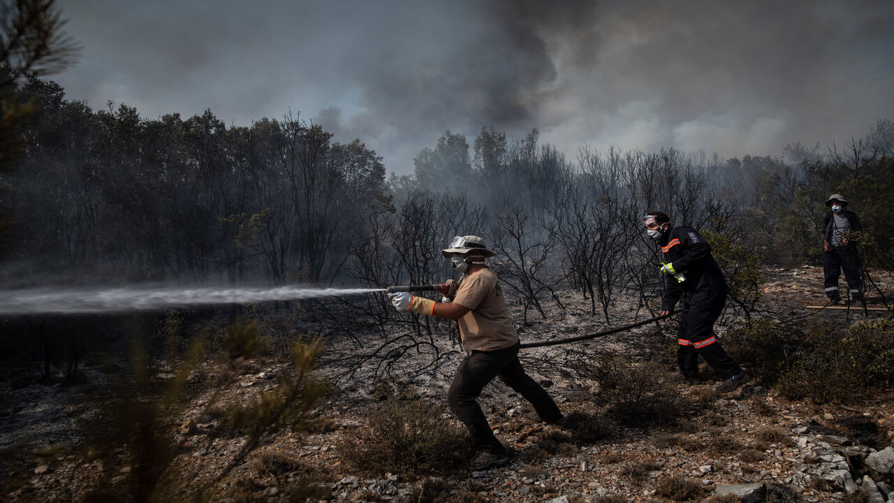 Firefighters battle a large wildfire near the village of Ikizce, in Mugla province, Turkey, Aug. 6, 2021.