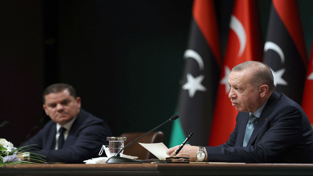 Turkish President Recep Tayyip Erdogan (R) and Libyan Government of National Unity Prime Minister Abdulhamid Dbeibeh attend a signing ceremony after their meeting at the presidential palace, Ankara, Turkey, April 12, 2021.