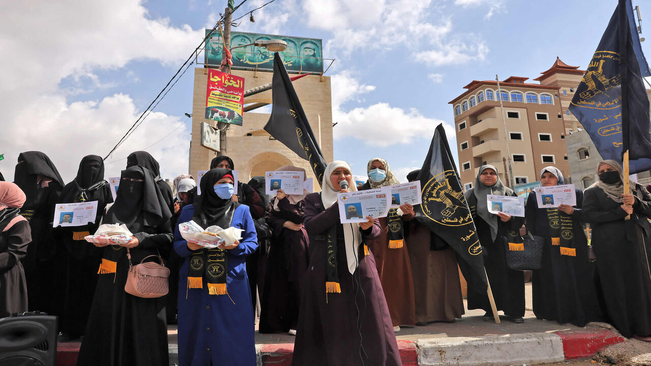Supporters of Islamic Jihad distribute sweets to celebrate the escape of six Palestinians from an Israeli prison, Rafah, Gaza Strip, Sept. 6, 2021.