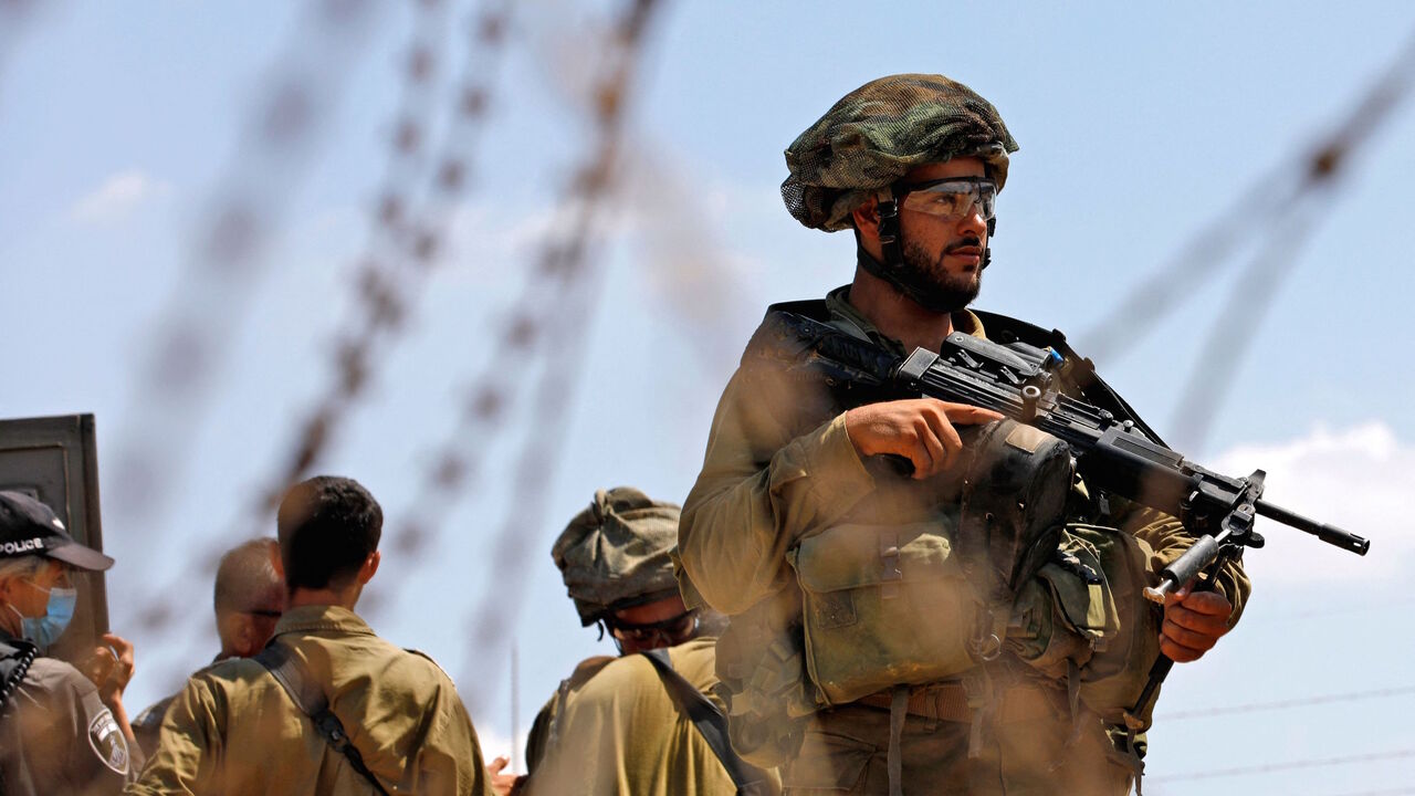 Israeli security forces patrol along the security fence in the village of Muqeibila near the West Bank town of Jenin on Sept. 6, 2021, following the escape of six Palestinians from an Israeli prison. 