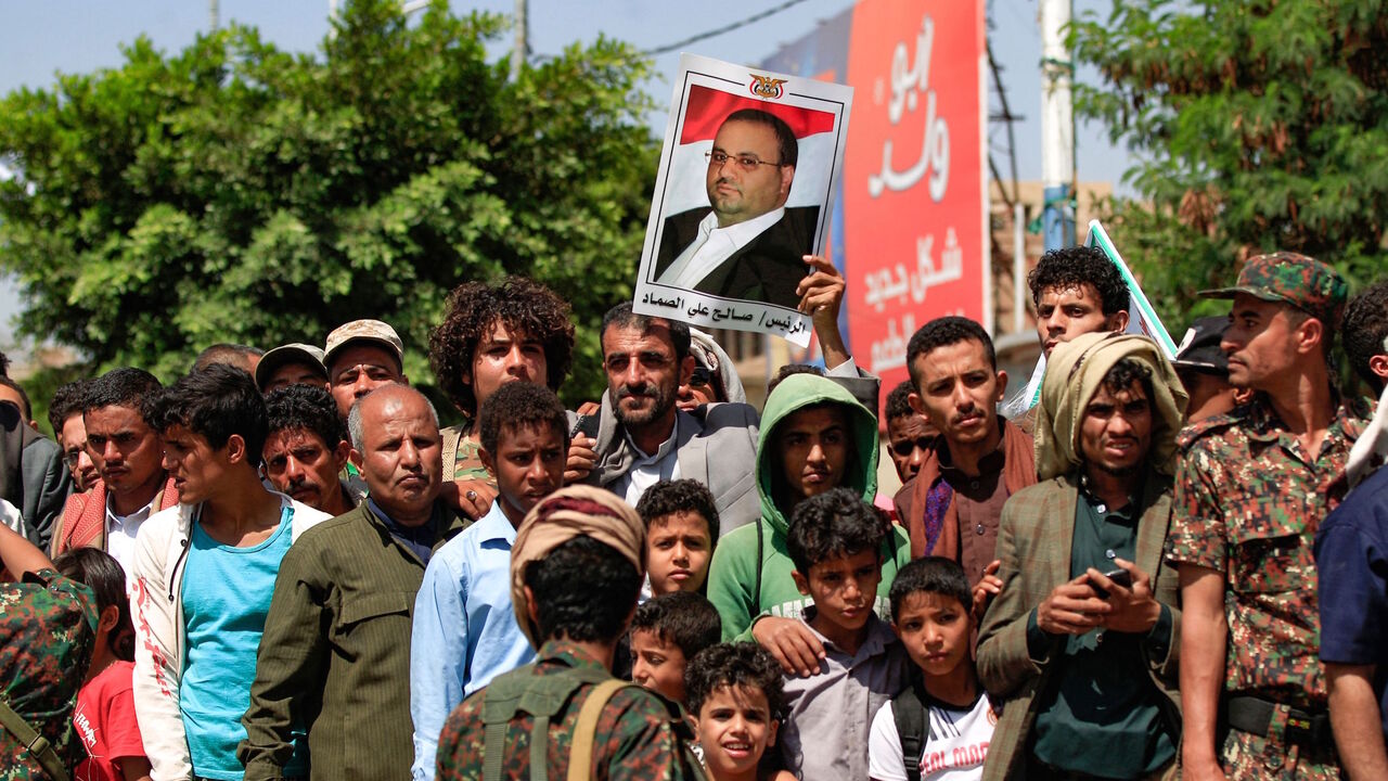 Yemeni men and children watch the execution of nine men, convicted of involvement in the assassination of Huthi political leader Saleh al-Sammad three years ago, at a public square in the Yemeni capital Sanaa, on Sept. 18, 2021. 